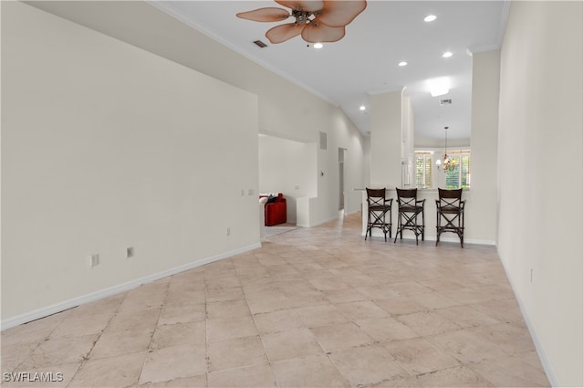 empty room featuring crown molding and ceiling fan with notable chandelier