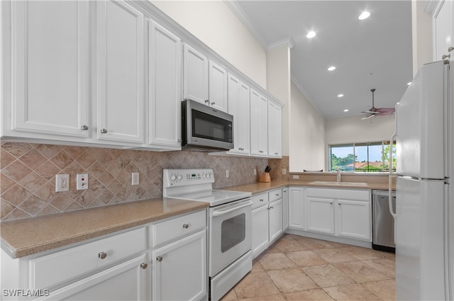 kitchen with crown molding, sink, white cabinetry, and stainless steel appliances