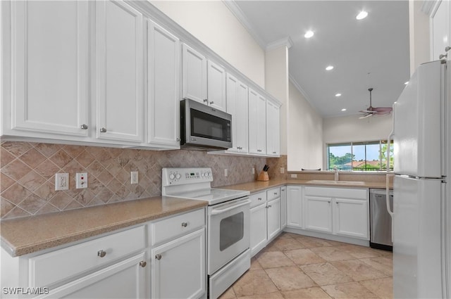 kitchen featuring appliances with stainless steel finishes, a sink, ceiling fan, ornamental molding, and recessed lighting