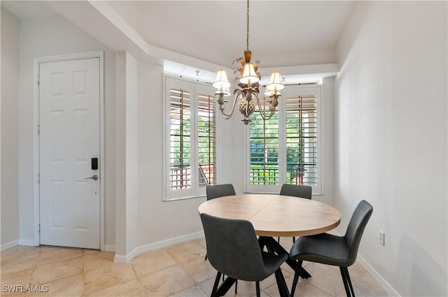 dining space with a chandelier and baseboards