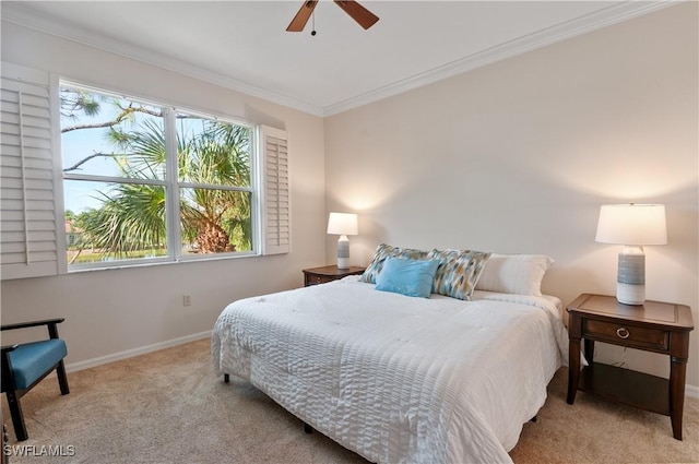 carpeted bedroom featuring crown molding, baseboards, and a ceiling fan