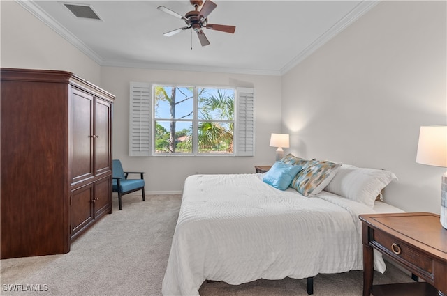 bedroom featuring ornamental molding, light colored carpet, and ceiling fan