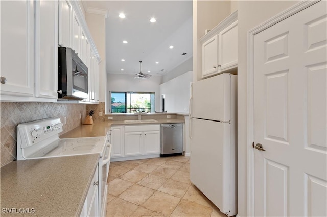 kitchen featuring appliances with stainless steel finishes, a sink, tasteful backsplash, ceiling fan, and white cabinetry