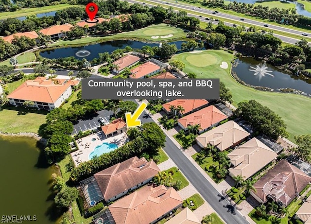 aerial view of property's location featuring a golf club, nearby suburban area, a nearby body of water, and a pool