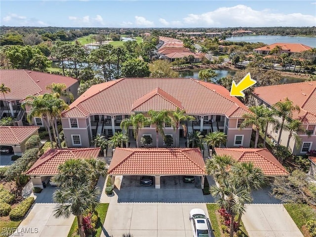 aerial view of residential area featuring a nearby body of water
