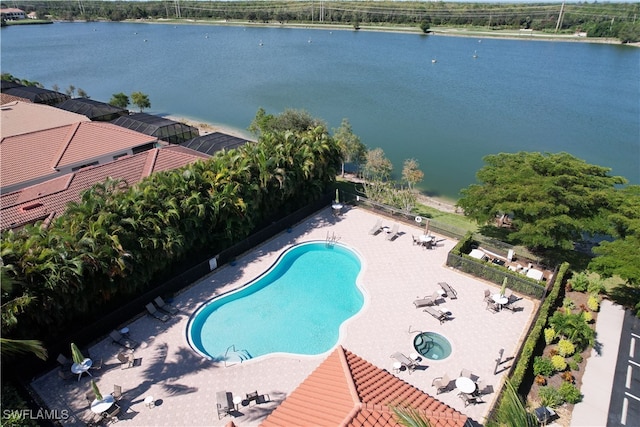 view of swimming pool featuring a water view and a patio area