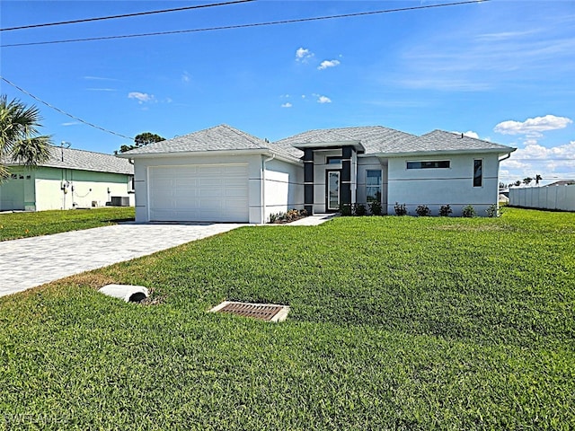 view of front of property featuring a garage and a front lawn