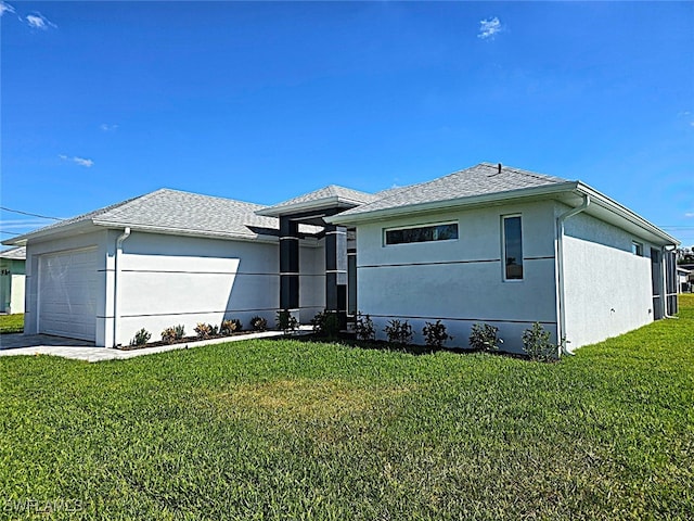 view of front of home with a front lawn and a garage