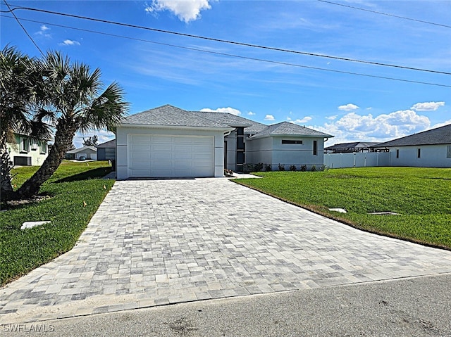 view of front of property featuring a front yard and a garage