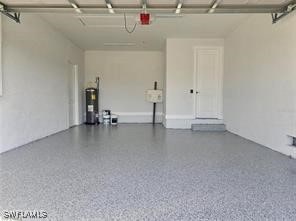 garage featuring a garage door opener and water heater