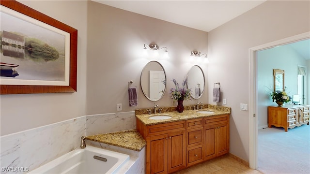 bathroom with vanity and a relaxing tiled tub