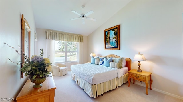 carpeted bedroom with ceiling fan and vaulted ceiling