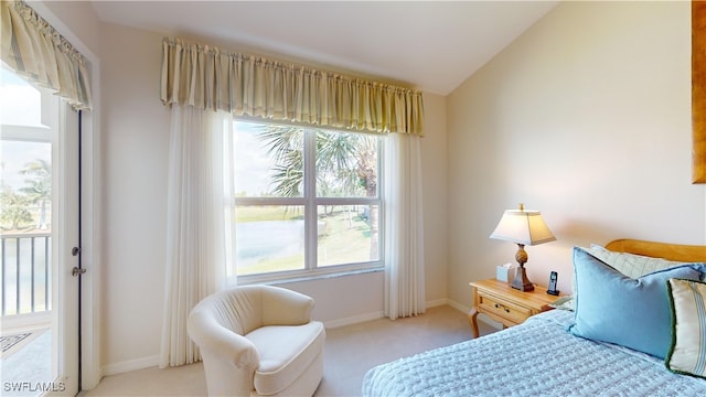 bedroom with light colored carpet and vaulted ceiling