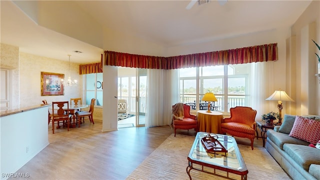 living room featuring an inviting chandelier and light hardwood / wood-style flooring