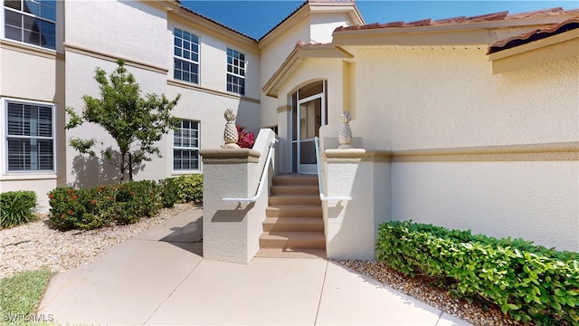 view of exterior entry featuring a patio