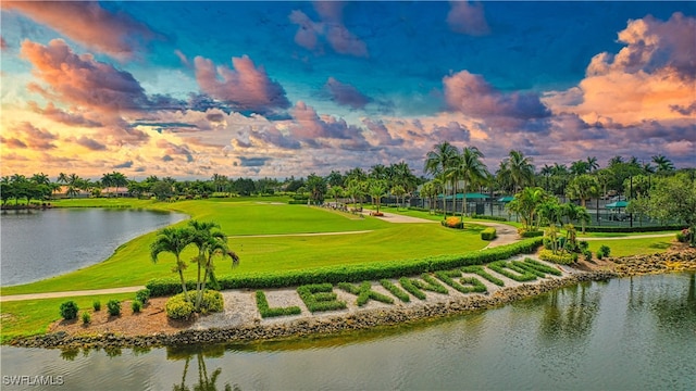 view of community featuring a water view and a yard