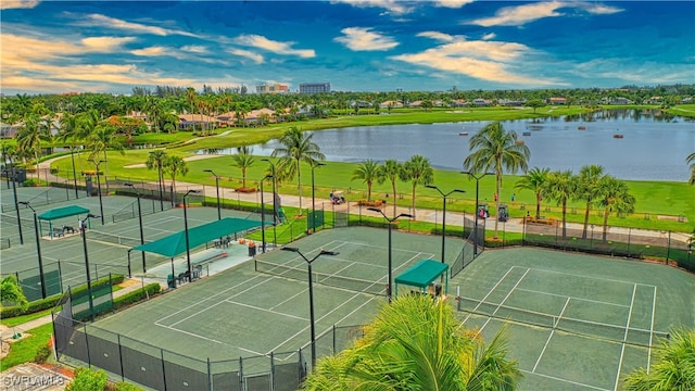 view of tennis court with a water view