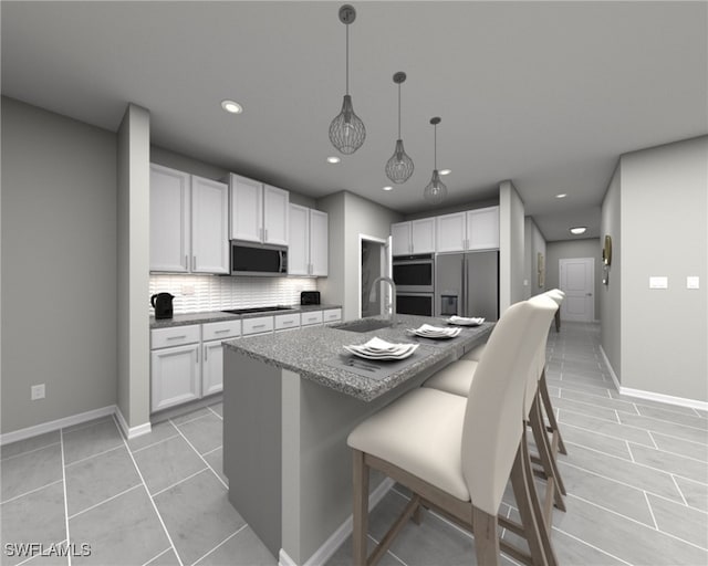 kitchen featuring white cabinetry, sink, appliances with stainless steel finishes, an island with sink, and decorative backsplash