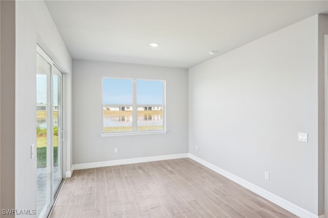 44290 Frontier Dr, Punta Gorda, FL 33982 - spare room with a water view and light wood-type flooring