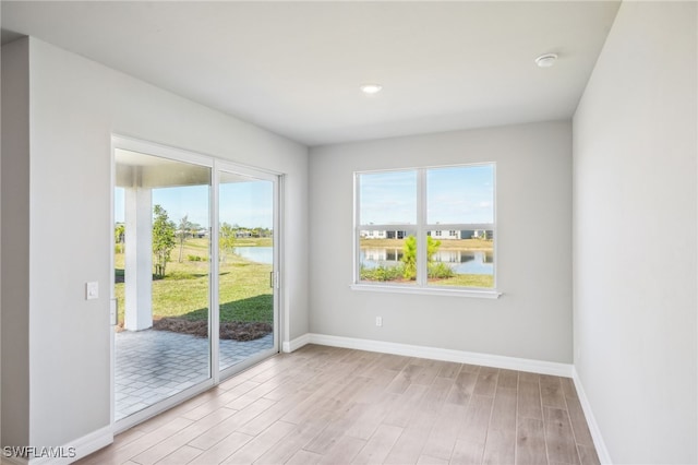44290 Frontier Dr, Punta Gorda, FL 33982 - spare room featuring a water view and light hardwood / wood-style floors