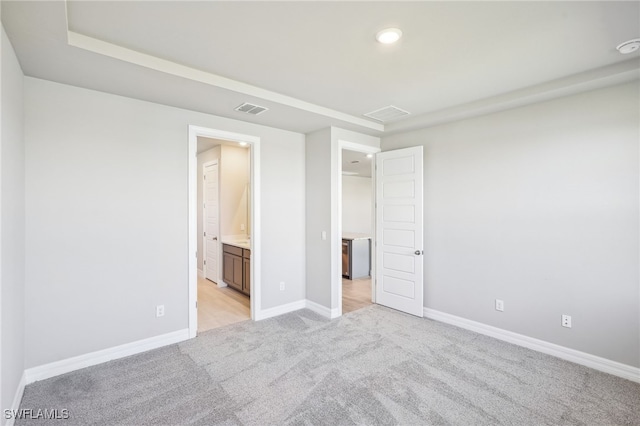 44290 Frontier Dr, Punta Gorda, FL 33982 - unfurnished bedroom featuring light carpet and ensuite bathroom