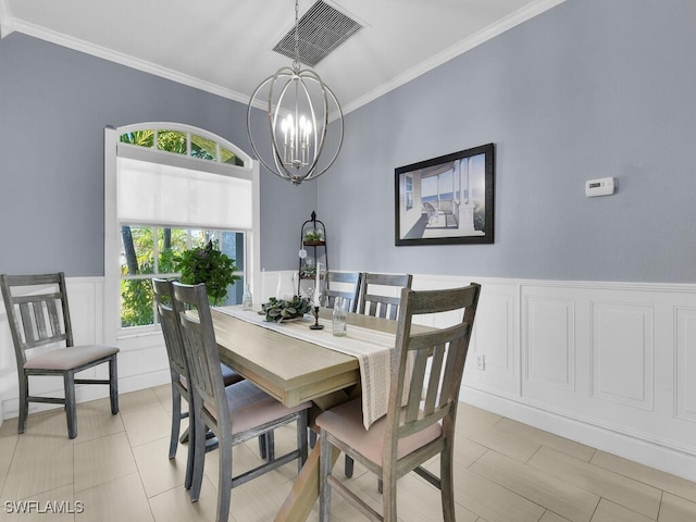 dining area with crown molding and a notable chandelier