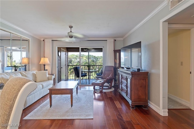 living room featuring ceiling fan, ornamental molding, and dark hardwood / wood-style flooring