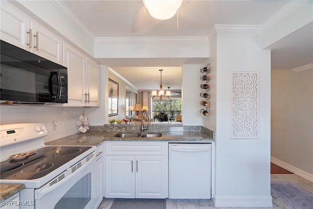 kitchen featuring white cabinetry, sink, white appliances, and a chandelier