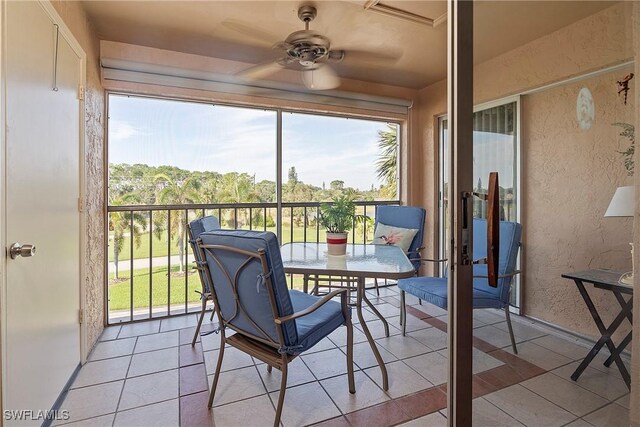 sunroom featuring ceiling fan