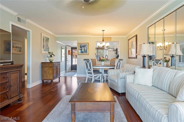 living room with ornamental molding, a notable chandelier, and dark hardwood / wood-style flooring