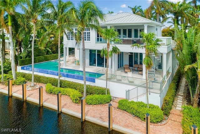 exterior space featuring a balcony, a water view, and a patio