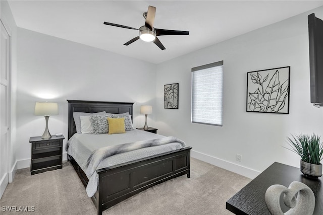 bedroom featuring light carpet and ceiling fan