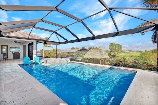 view of pool with a patio, ceiling fan, and a lanai