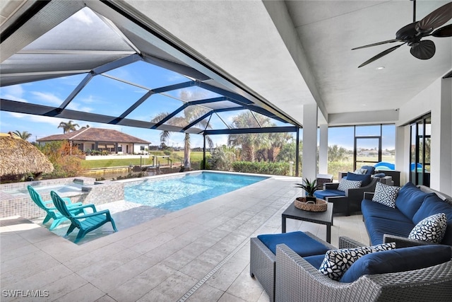 view of swimming pool with outdoor lounge area, a jacuzzi, ceiling fan, a lanai, and a patio area