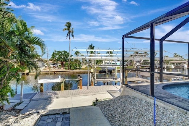 view of dock with a lanai and a water view