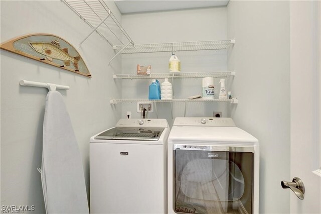 washroom with independent washer and dryer