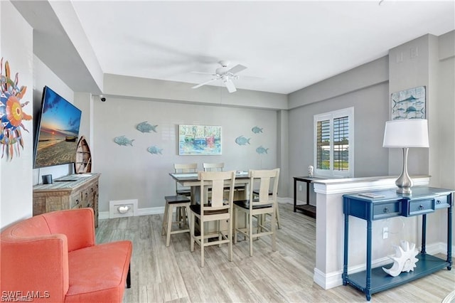 dining room with ceiling fan and light hardwood / wood-style flooring