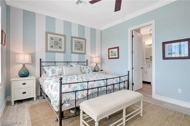 bedroom featuring light wood-type flooring, ensuite bath, ceiling fan, and ornamental molding