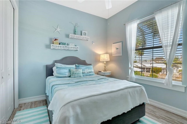 bedroom featuring ceiling fan, a closet, and light hardwood / wood-style flooring