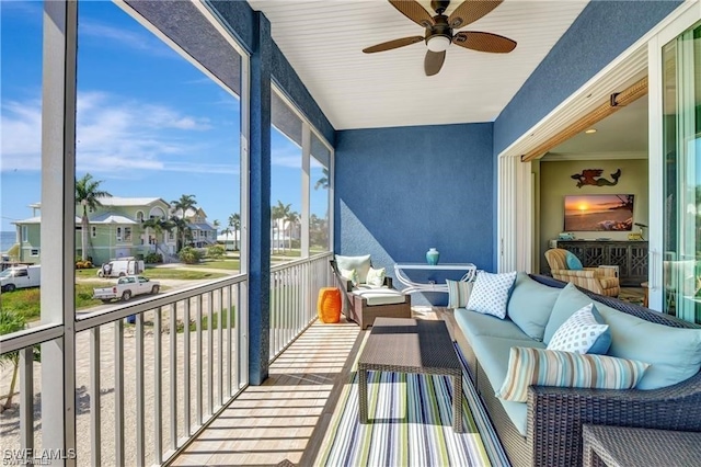 sunroom / solarium featuring ceiling fan