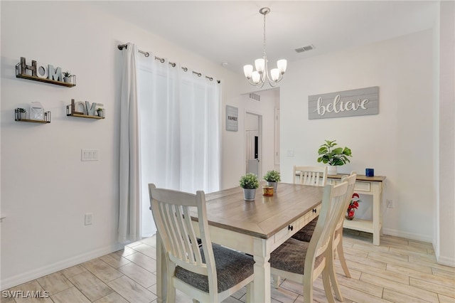 dining area featuring a chandelier and light hardwood / wood-style floors