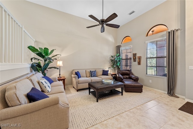 living room with ceiling fan, high vaulted ceiling, and light tile patterned flooring