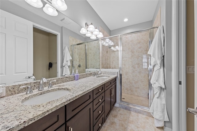 bathroom featuring vanity, an enclosed shower, and tile patterned flooring