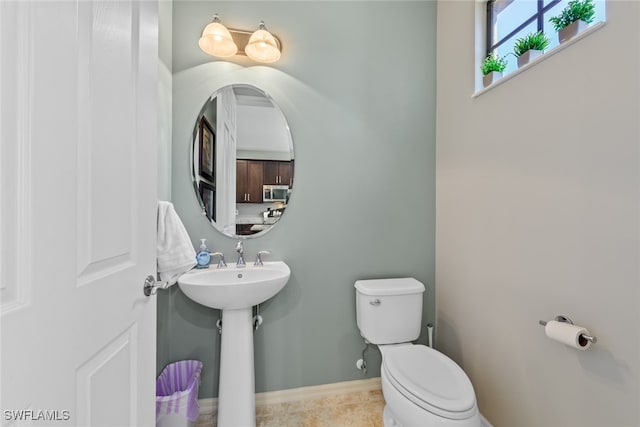 bathroom with toilet and tile patterned flooring