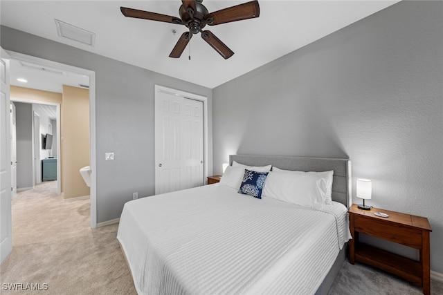 carpeted bedroom featuring a closet and ceiling fan