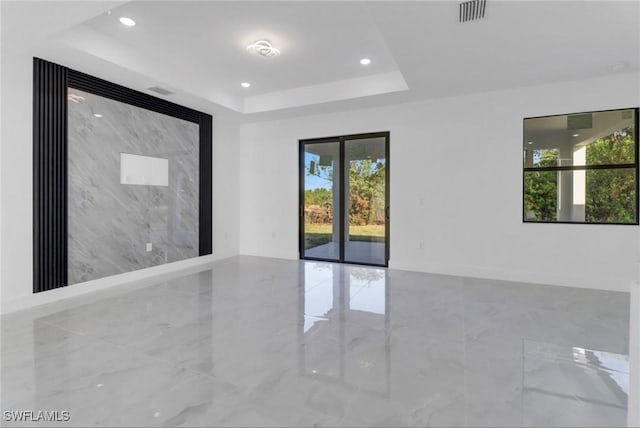 unfurnished room with a raised ceiling