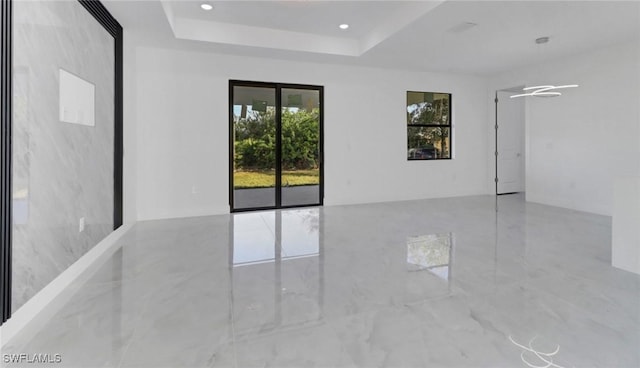 empty room featuring a tray ceiling