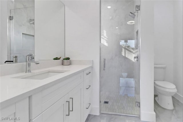 bathroom with vanity, toilet, and a shower with shower door