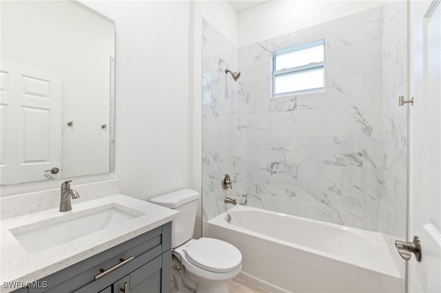 full bathroom featuring vanity, toilet, and tiled shower / bath combo