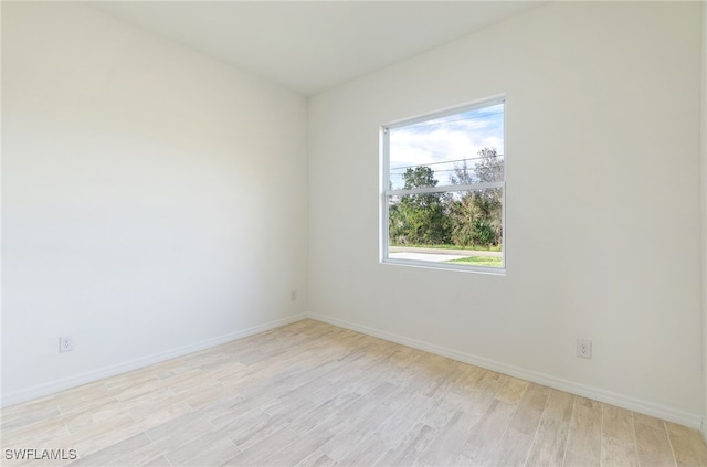 unfurnished room with light hardwood / wood-style floors